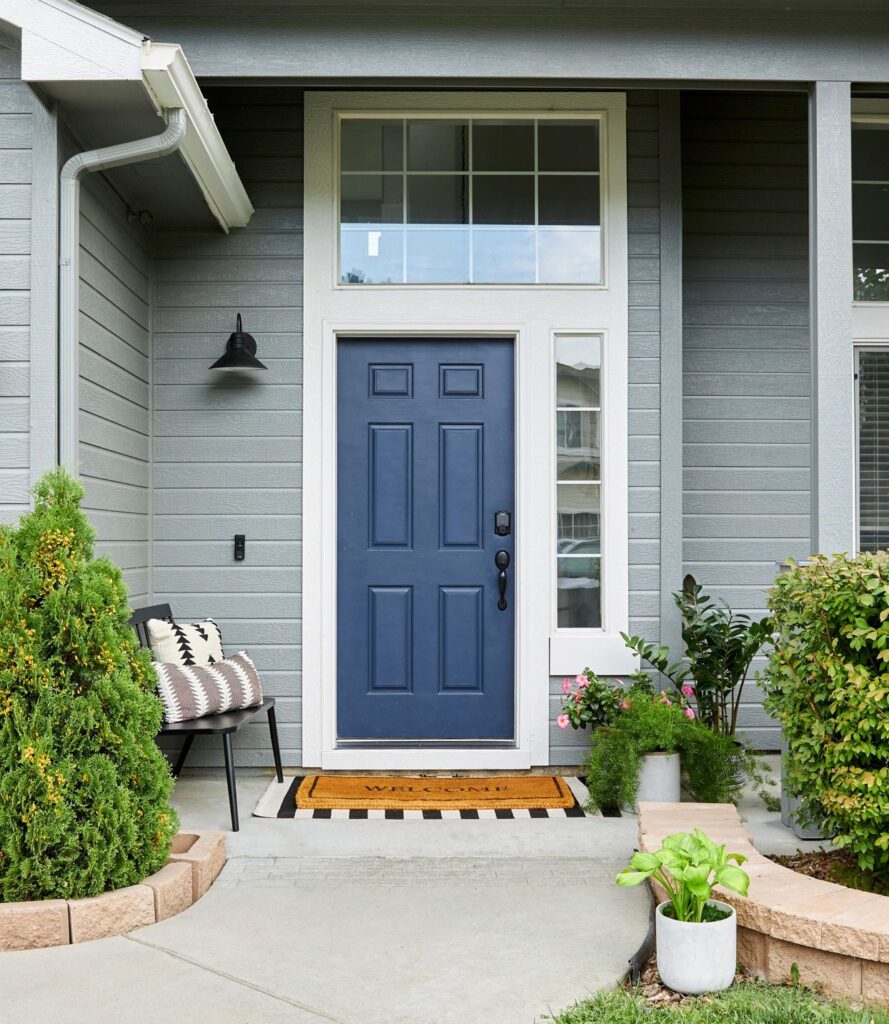 exterior-gray-siding-navy-front-door-porch-CsAM7t_8qFCAhAyEFBtWdL-0f3c1e2524a3477db4b64e56c687ec62